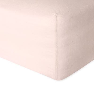 Linen fitted sheet in pink showing the corner detail. Scooms