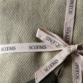 Close-up of a herringbone-patterned green coloured Merino lambswool throw with 'Scooms' branding.
