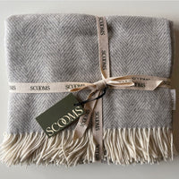 Herringbone-patterned grey coloured Merino lambswool throw with 'Scooms' branding.