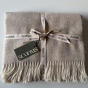 Herringbone-patterned natural coloured Merino lambswool throw with 'Scooms' branding.