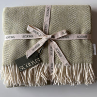 Herringbone-patterned sage green Merino lambswool throw with 'Scooms' branding.