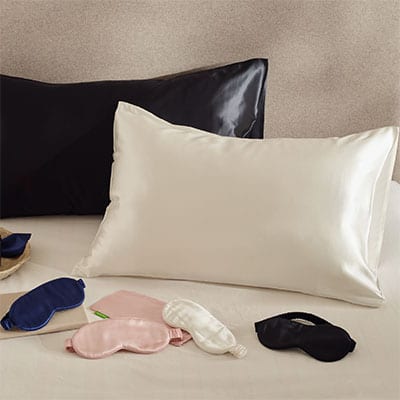 Silk pillowcases in ivory and black with ivory, black, blue and pink silk eye masks. Scooms