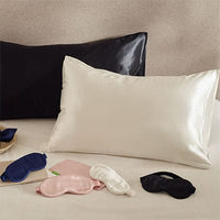 Silk pillowcases in ivory and black with ivory, black, blue and pink silk eye masks. Scooms