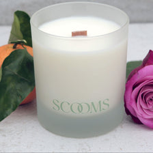 Natural scented candle in a frosted reusable glass jar with an orange, rose and leaves | Scooms