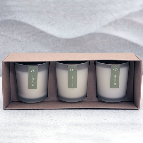 Three natural scented candles in a discovery box set on a textured surface | Scooms