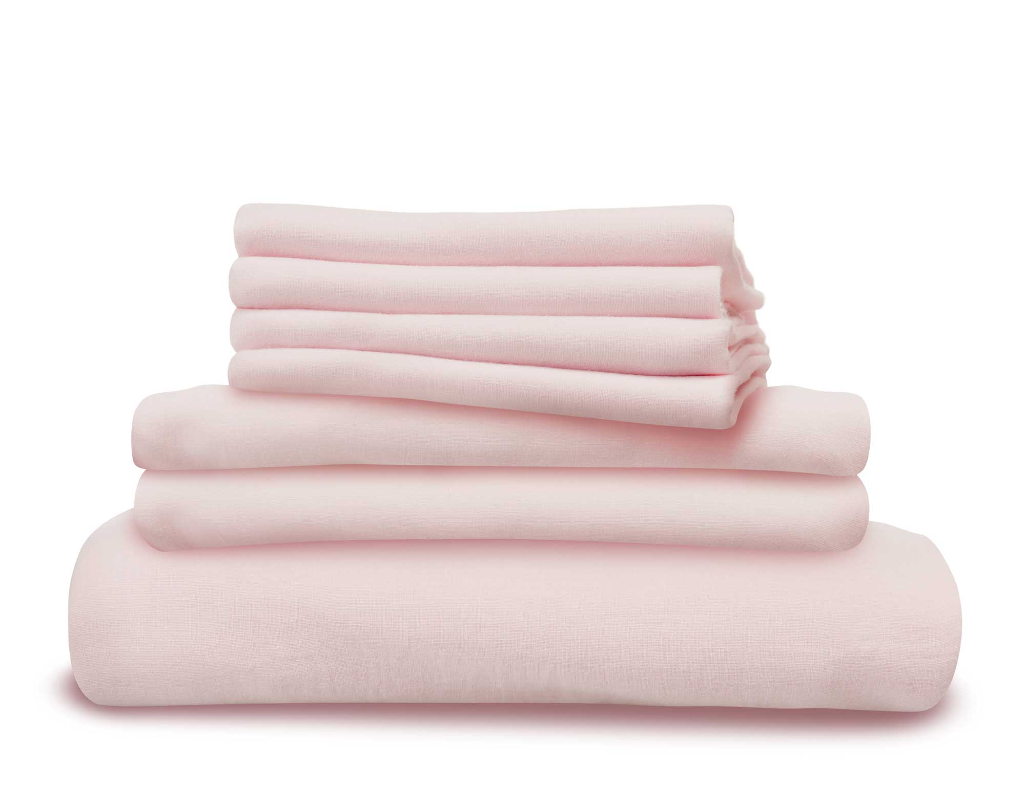 Pink linen bedding folded and in a pile
