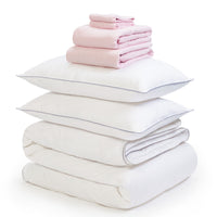 Pink linen bedding bundle consisting of a pair of pillows, an all seasons 13.5 tog (4.5 tog + 9 tog) down duvet linen duvet cover, linen sheet and linen pillowcases. Scooms