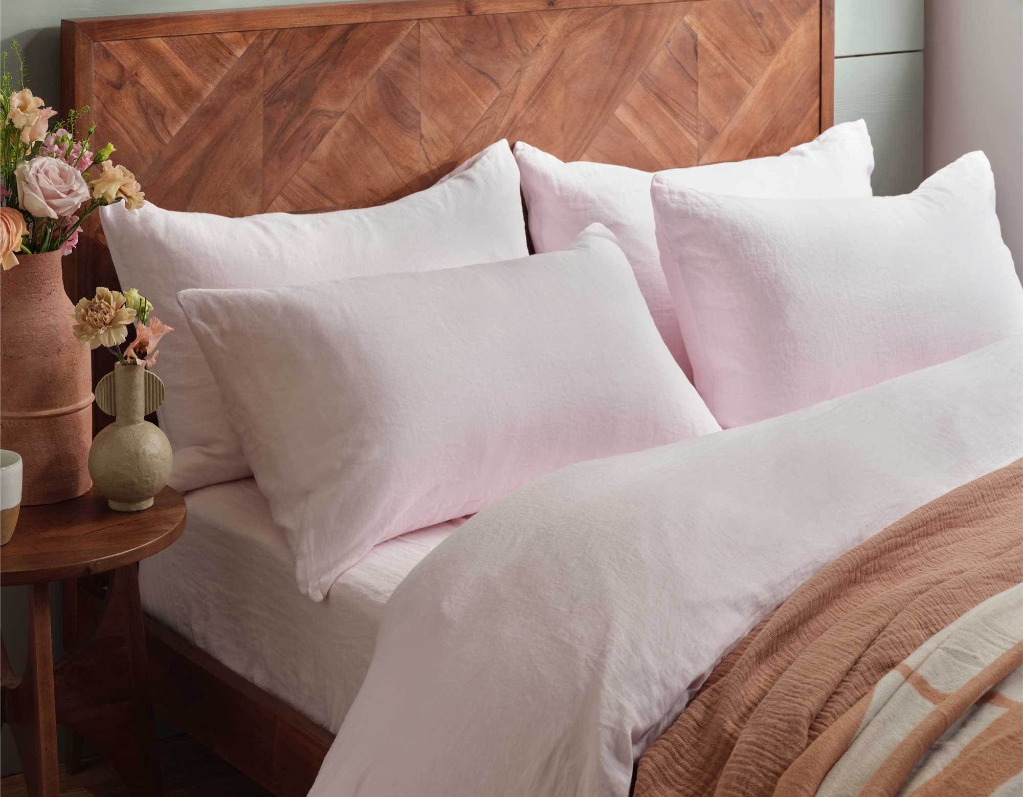 Pink Linen Sheets on Wooden Bed