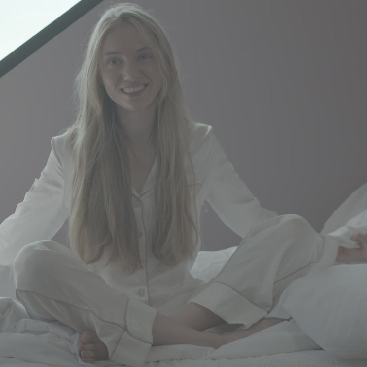 Female on a bed wrapped in a Scooms goose down duvet
