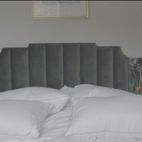 Female jumping on bed with pillows