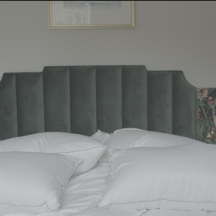 Female jumping on bed with pillows