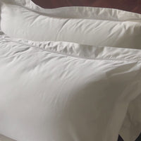 Luxury bedroom setting with white Egyptian cotton pillowcases. Scooms