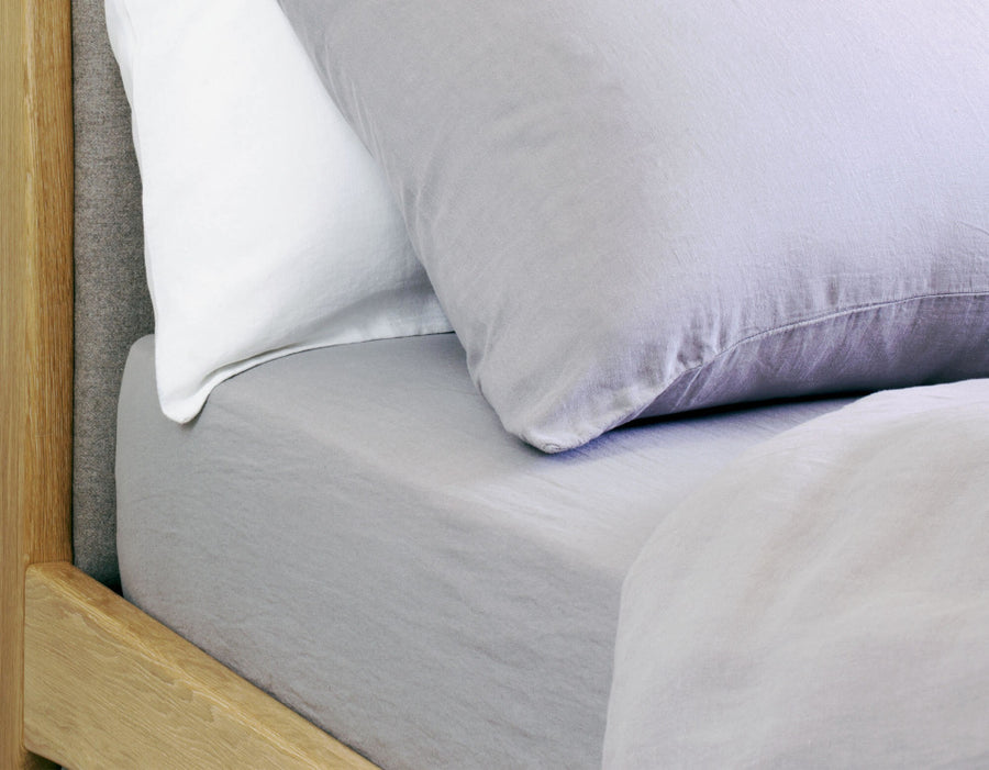 Grey double linen fitted sheet on bed