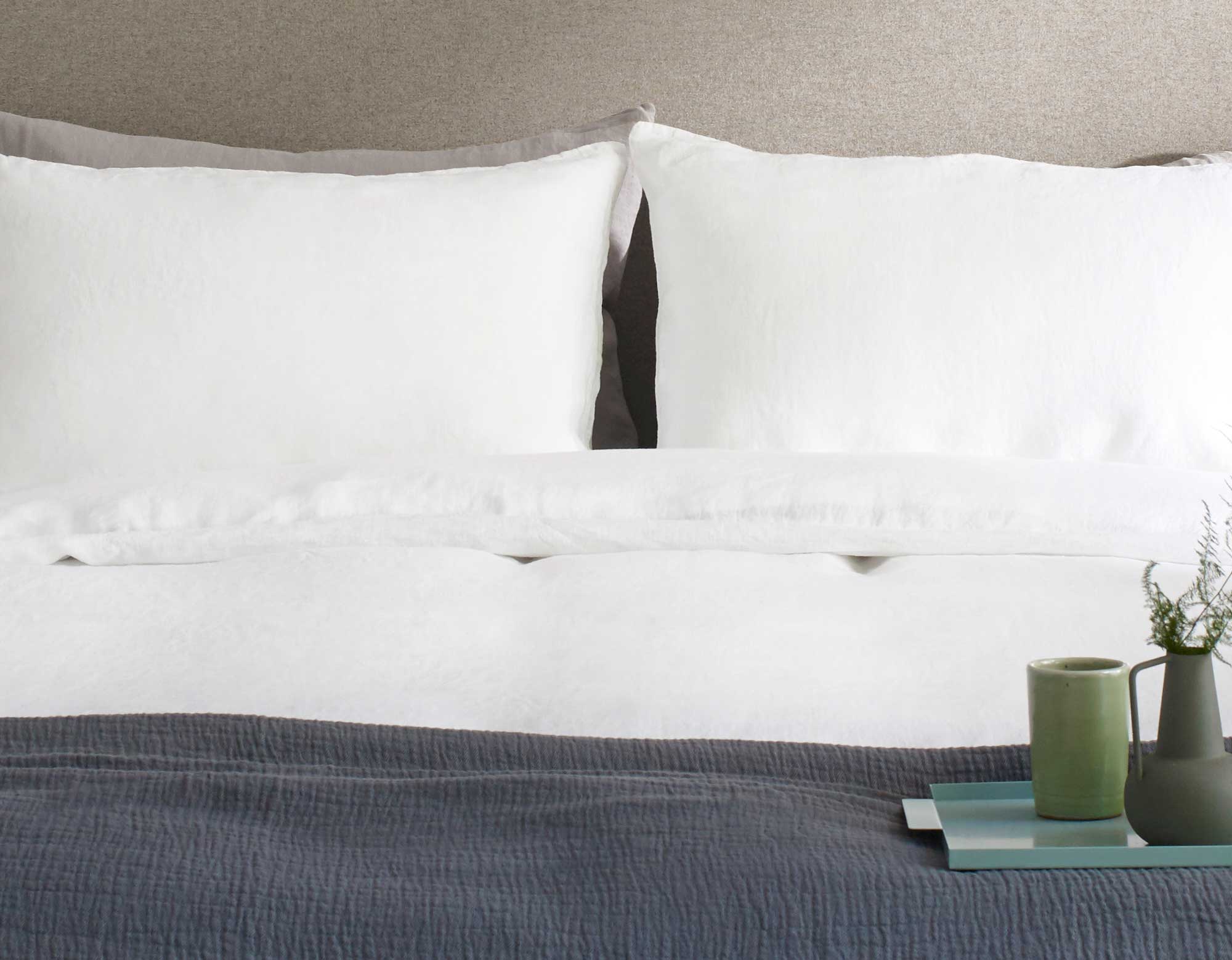 White linen duvet cover on bed with breakfast in bed 