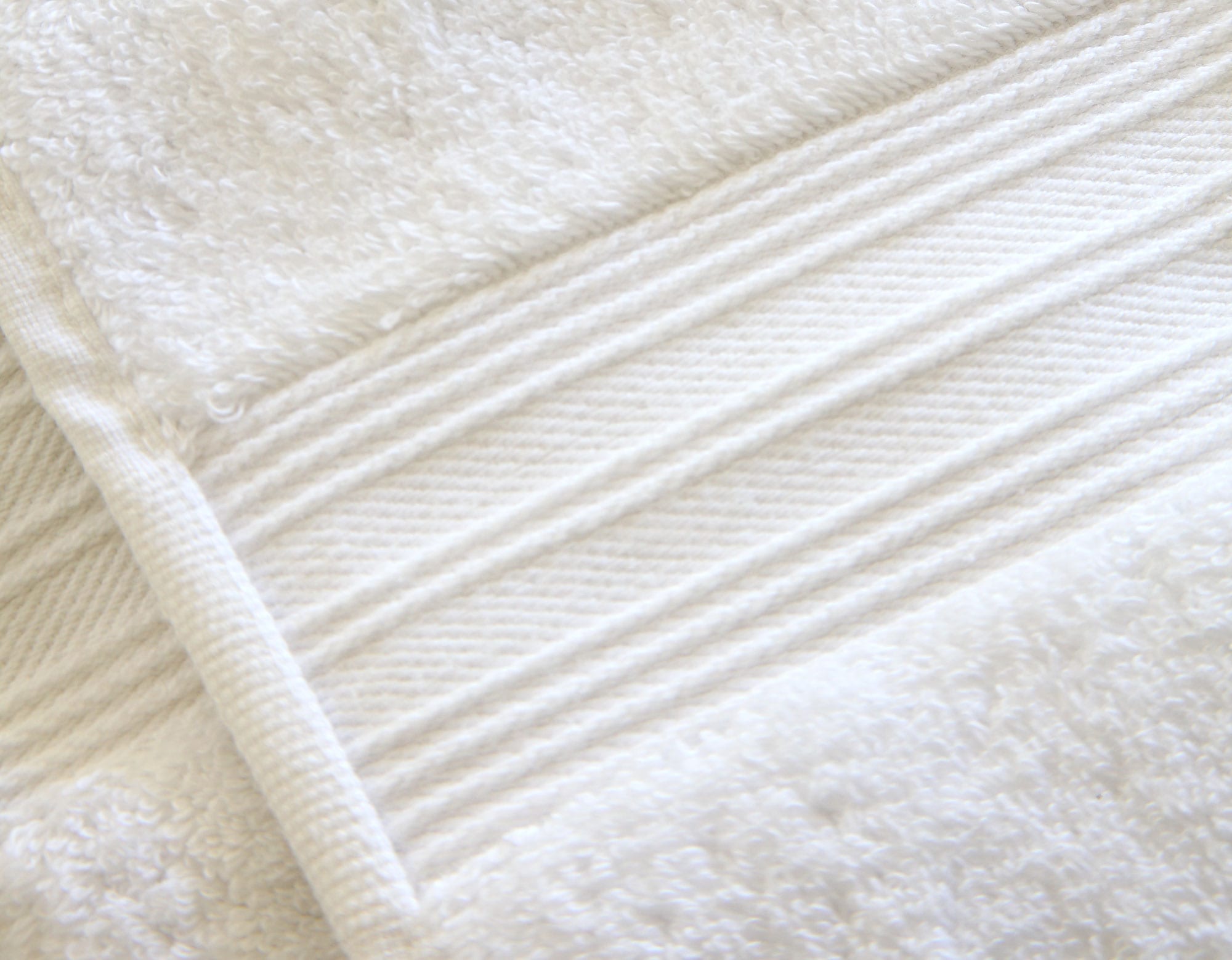 Close-up of white Egyptian cotton bath sheet detailing edging and hem