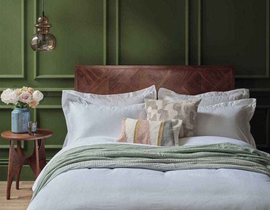 White Egyptian cotton bedding on bed in luxury bedroom