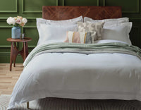 Egyptian cotton duvet cover and pillowcases with Oxford border on made bed