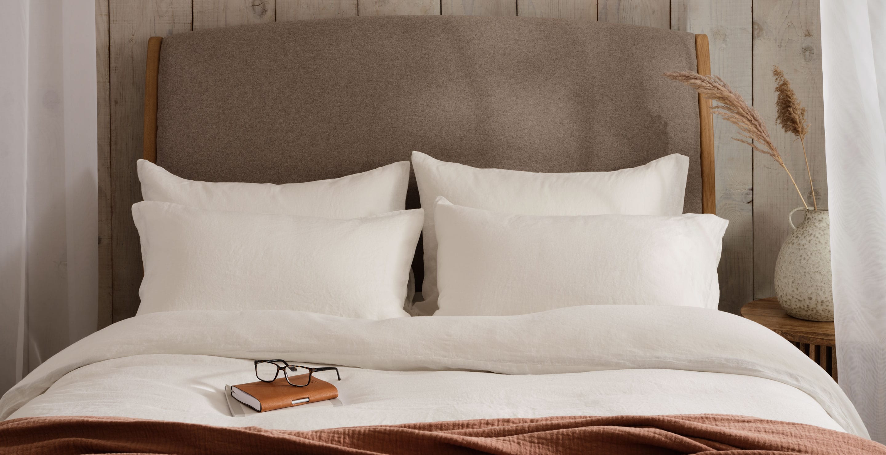 White linen bedding on a bed with an autumnal feel. Scooms