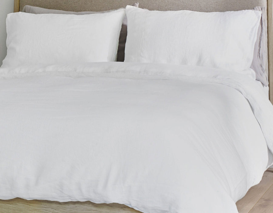 White double linen fitted sheet and grey linen pillowcases on bed