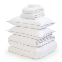 White linen bedding bundle consisting of a pair of pillows, an all seasons 13.5 tog (4.5 tog + 9 tog) down duvet, linen duvet cover, linen sheet and linen pillowcases. Scooms
