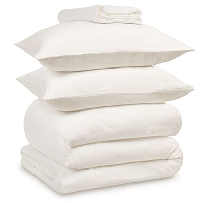 White linen bedding bundle consisting of a pair of pillows, an all seasons 13.5 tog (4.5 tog + 9 tog) down duvet, linen duvet cover, linen sheet and linen pillowcases. Scooms
