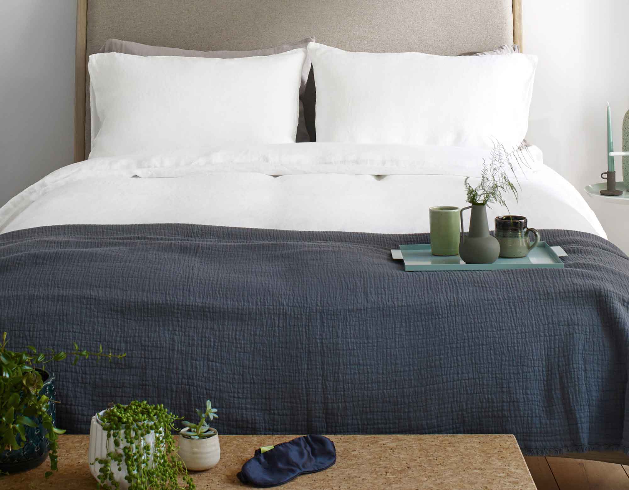 White Linen Bed Sheets with a Blue Throw on Bed