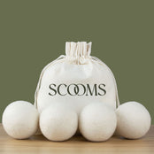 Wool dryer balls with a Scooms branded cotton storage bag .Scooms