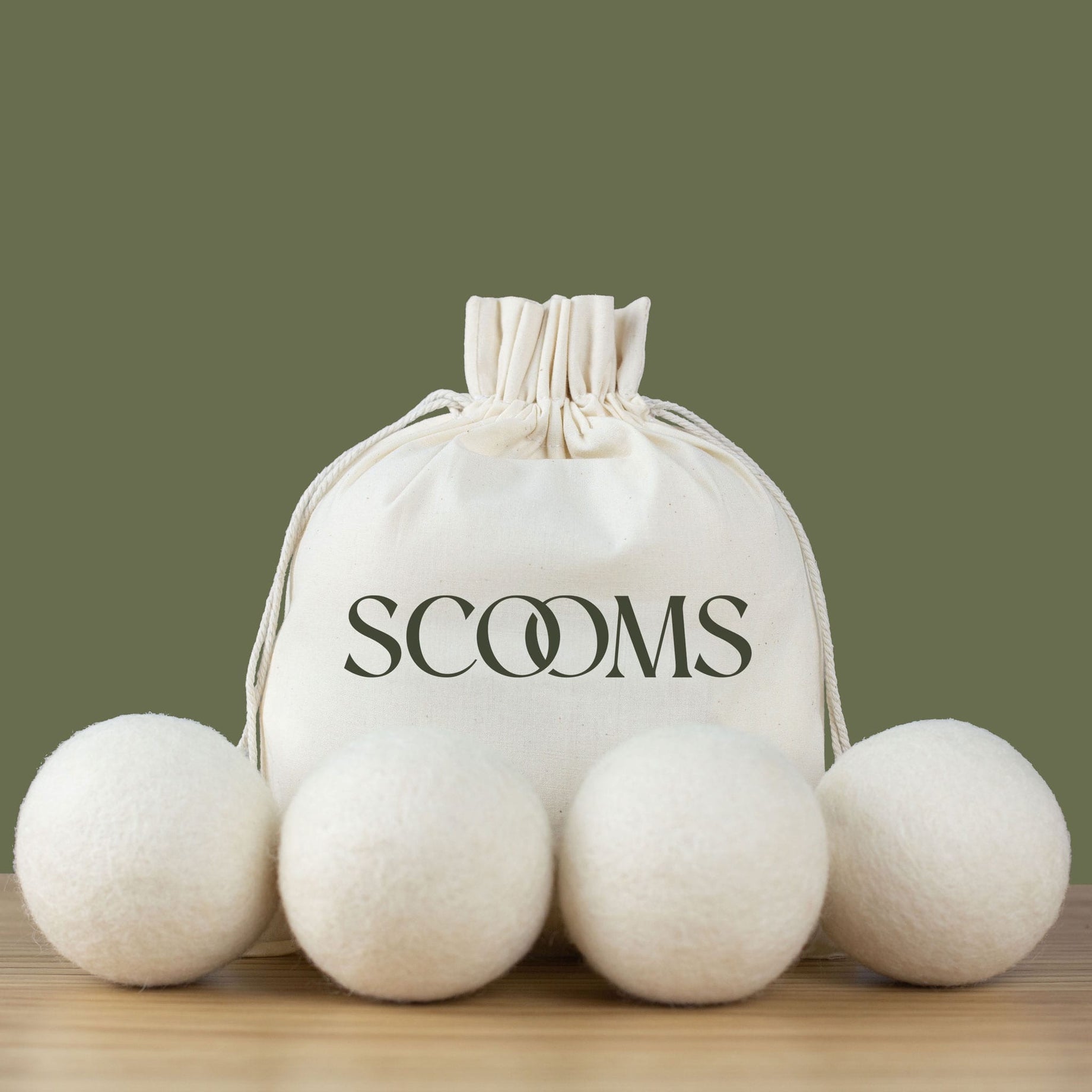 Wool dryer balls with a Scooms branded cotton storage bag .Scooms